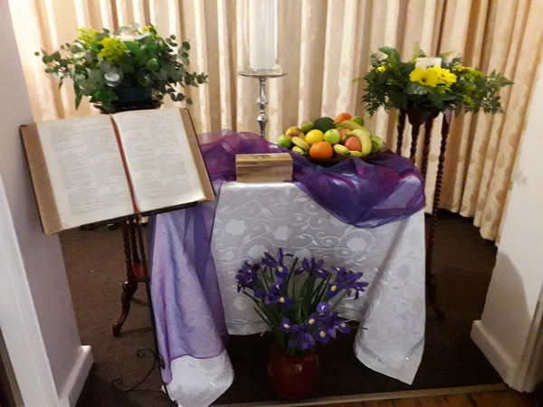 A beautifully arranged table featuring vibrant flowers alongside an open Bible, symbolizing faith and nature's beauty. A beautifully arranged table featuring vibrant flowers alongside an open Bible, symbolizing faith and nature's beauty.