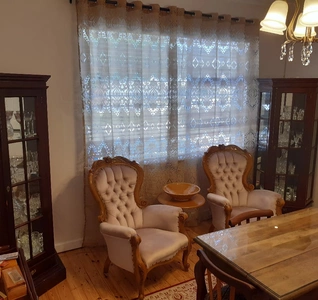 A lounge featuring a table surrounded by several chairs, creating an inviting atmosphere