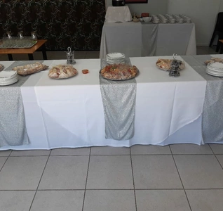 A table adorned with an array of food items and neatly arranged plates.