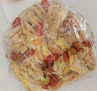 A collection of sandwiches neatly packaged.